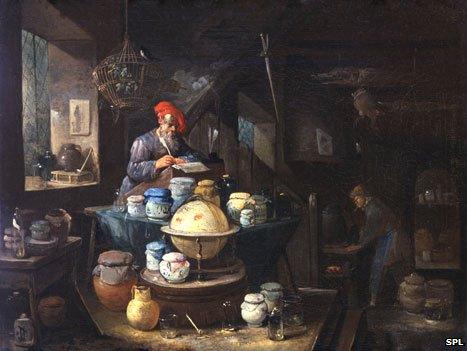 17th Century painting showing an alchemist and his servant in a cluttered study