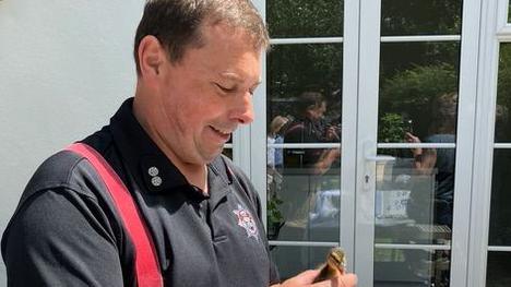 one of the rescuers holding a duckling