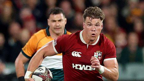 Huw Jones runs with the ball