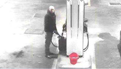 CCTV image of Calum Sunderland filling a petrol canister at a petrol station.