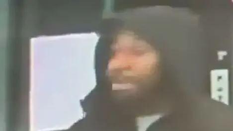 A blurred CCTV image of Anthony, a man wearing a black hoodie.
