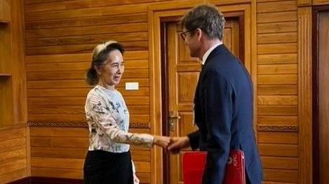 Former Myanmar president Aung San Suu Kyi talks to Arnaud de Baecque, resident representative of the International Committee of the Red Cross