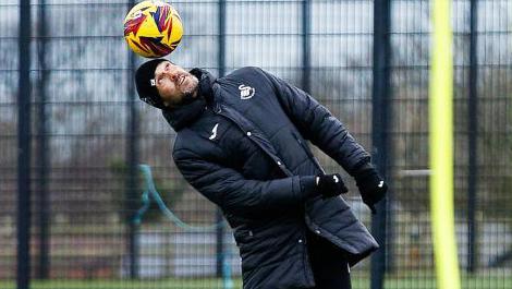 Swansea boss Luke Williams heading a ball