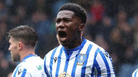 Di'Shon Bernard celebrating with mouth open after scoring for Sheffield Wednesday against Cardiff City.