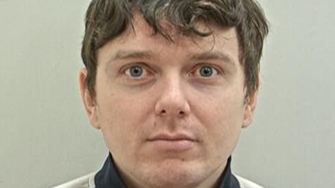 A mugshot of Andrew Sullivan, who has tousled brown hair and is clean shaven.