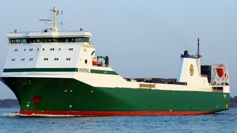 A long green ship with a white top and the name Mistral on the side. 