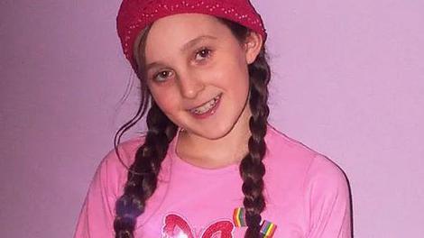 Rosie Mayling in a pink t-shirt and a pink beanie hat looking at the camera