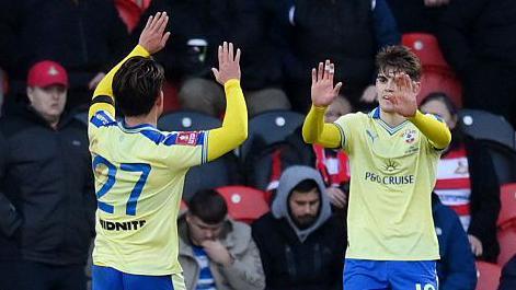 Southampton players Kuryu Matsuki moves towards Tom Fellows with his hands up ready to make a high five as the players celebrate the Japanese midfielder's goal at Doncaster Rovers in the FA Cup.