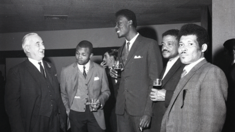 A group of men wearing suits in a social setting