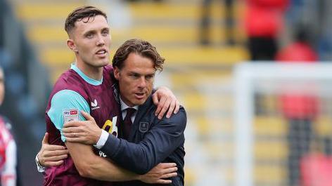 Dara O'Shea hugs Burnley boss Scott Parker