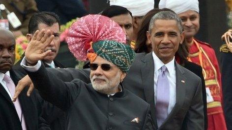 US President Barack Obama (R) and Indian Prime Minister Narendra Modi (L) wave to spectators after attending India"s Republic Day parade on Rajpath in New Delhi on January 26, 2015.