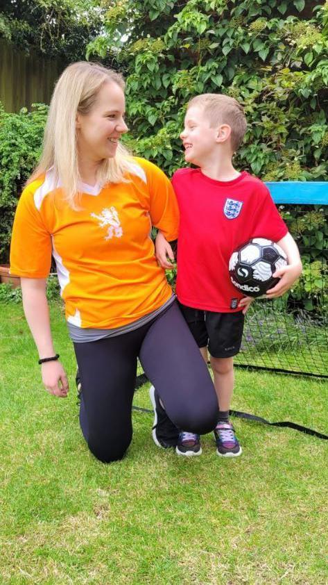 Emily Knight in a Holland football top looking at Edwyn, 6