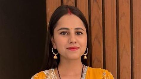 Harshita Brella wearing a yellow saree looking at the camera and smilling