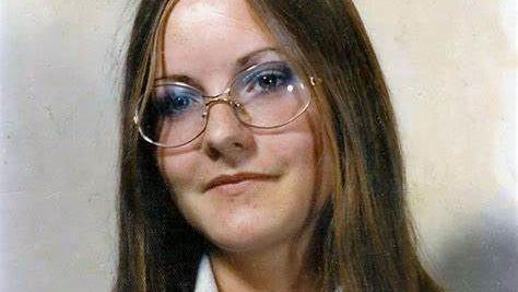 Lynne Weedon, a 16-year-old schoolgirl pictured in 1975. It is a formal individual school photo. She has long light brown hair and hazel eyes. She is wearing glasses and the collar of her school shirt can just be seen.