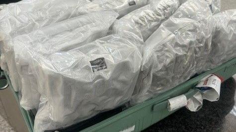 white cannabis bags in a suitcase on table