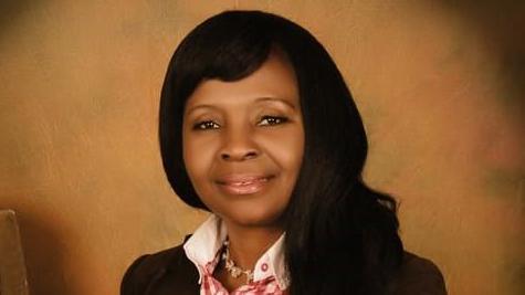 A woman with long black hair looking at the camera.