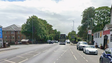 A busy road in Wakefield, with a restaurant on the right. A bus is in the distance and heading towards the camera.