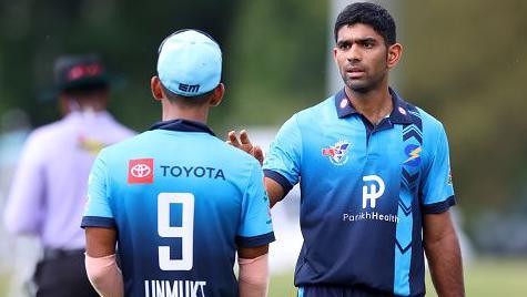 Bowler Saurabh Netravalkar #20 of the Silicon Valley Strikers gets the ball from captain Unmukt Chand #9 during the Minor League Cricket Pacific Conference Final between the Silicon Valley Strikers and Seattle Thunderbolts at Church Street Park on August 27, 2022 in Morrisville, North Carolina