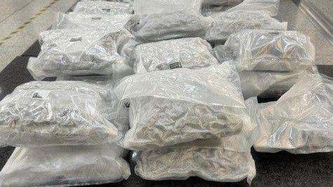 Vacuum-packed bags of cannabis piled up on a floor