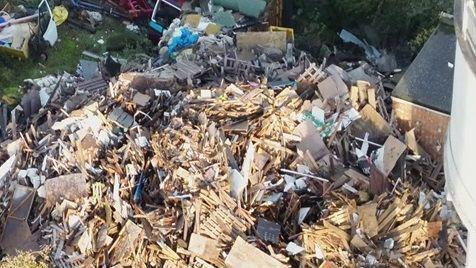 A huge pile of waste made up out of wood, metal, building waste and other mess.