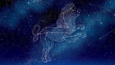 A stylised drawing of a lion over the Leo constellation in the night sky