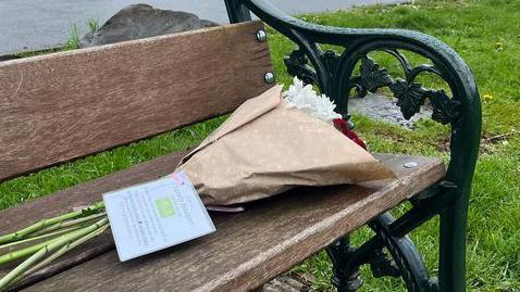 Flowers on a park bench 