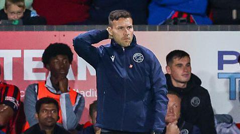 Walsall boss Mat Sadler scratches his head