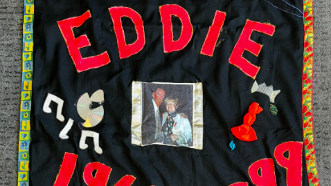 A black and red quilt comerating Eddie Boyne
