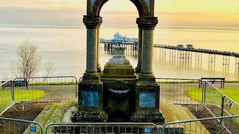 The empty and damaged plinth upon which a missing bust of Queen Victoria sat in Llandudno's Happy Valley garden 