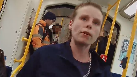 CCTV image of a woman, between 30 and 40 years old, of a medium build, and with shoulder-length brown hair on a tram