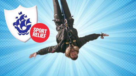 Richie hanging upside down from a bungee.