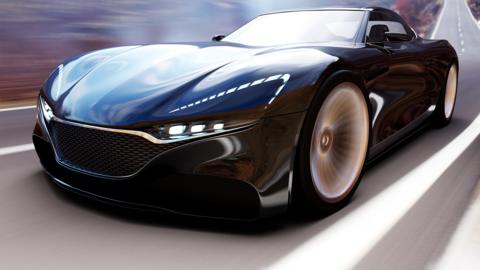 A sleek black supercar zooms down a road.