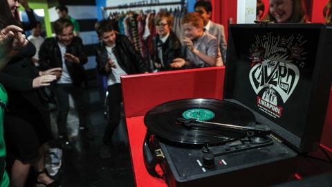 children-dancing-around-a-record-player.