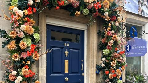 blue-door-with-flower-arch.