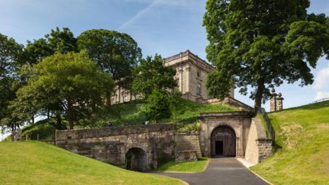 castle-grounds-with-trees-and-blue-sky.