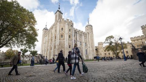 people-walking-on-cobbled-paths-in-front-of-tower-of-london.