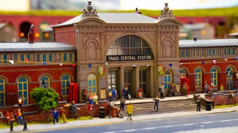 model_railway_with_tiny_people_and_buildings.