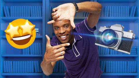 Rhys on a bookshelf background with a camera flash and emoji.