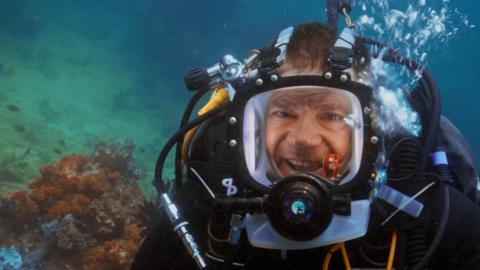 Image of Steve Backshall in diving equipment smiling under the sea.