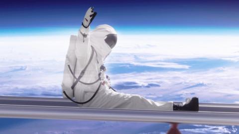 An astronaut is sliding down a big metal slide over planet earth