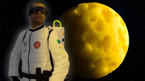 A young man in a space suit is looking bravely into the distance, behind him is a huge yellow moon made of cheese