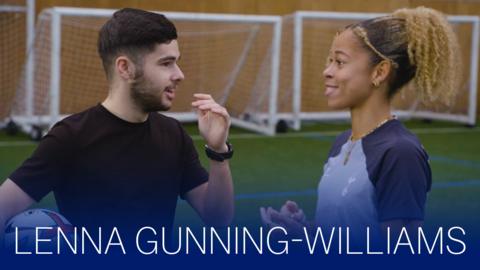 Jamie Johnson is laughing next to Lenna Gunning-Williams in a football club