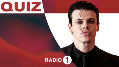 Yungblud, a young man dressed in black with slicked black hair.