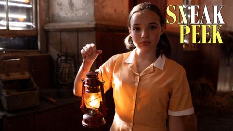 Celeste holds a lit lantern.