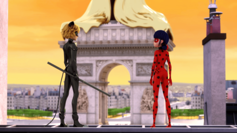 Ladybug and Cat Noir are standing in front of a french monument at sunset