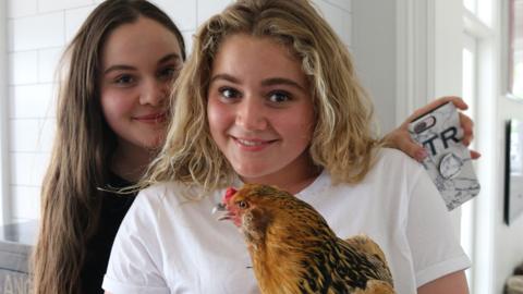 Tilly and Holly with their chicken Kevin