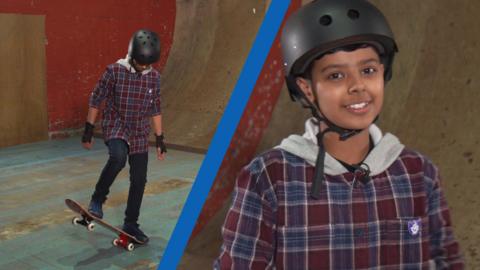 Young skateboarder practising a move to the left of screen; he is facing the camera smiling to the right of screen