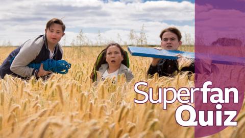 The Dumping Ground characters are crouched in a field looking a bit shocked.