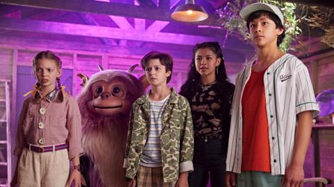 Four children next to a monster