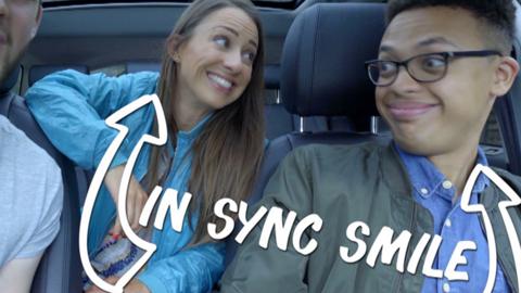 Rebecca Jackson and Sideways Sid in a car with an 'In Sync Smile'.